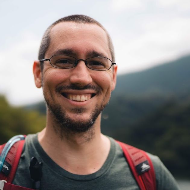 Caius Scipio smiling with mountains in the background